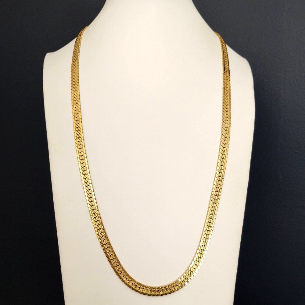 Long gold tone necklace with fold over clasp
